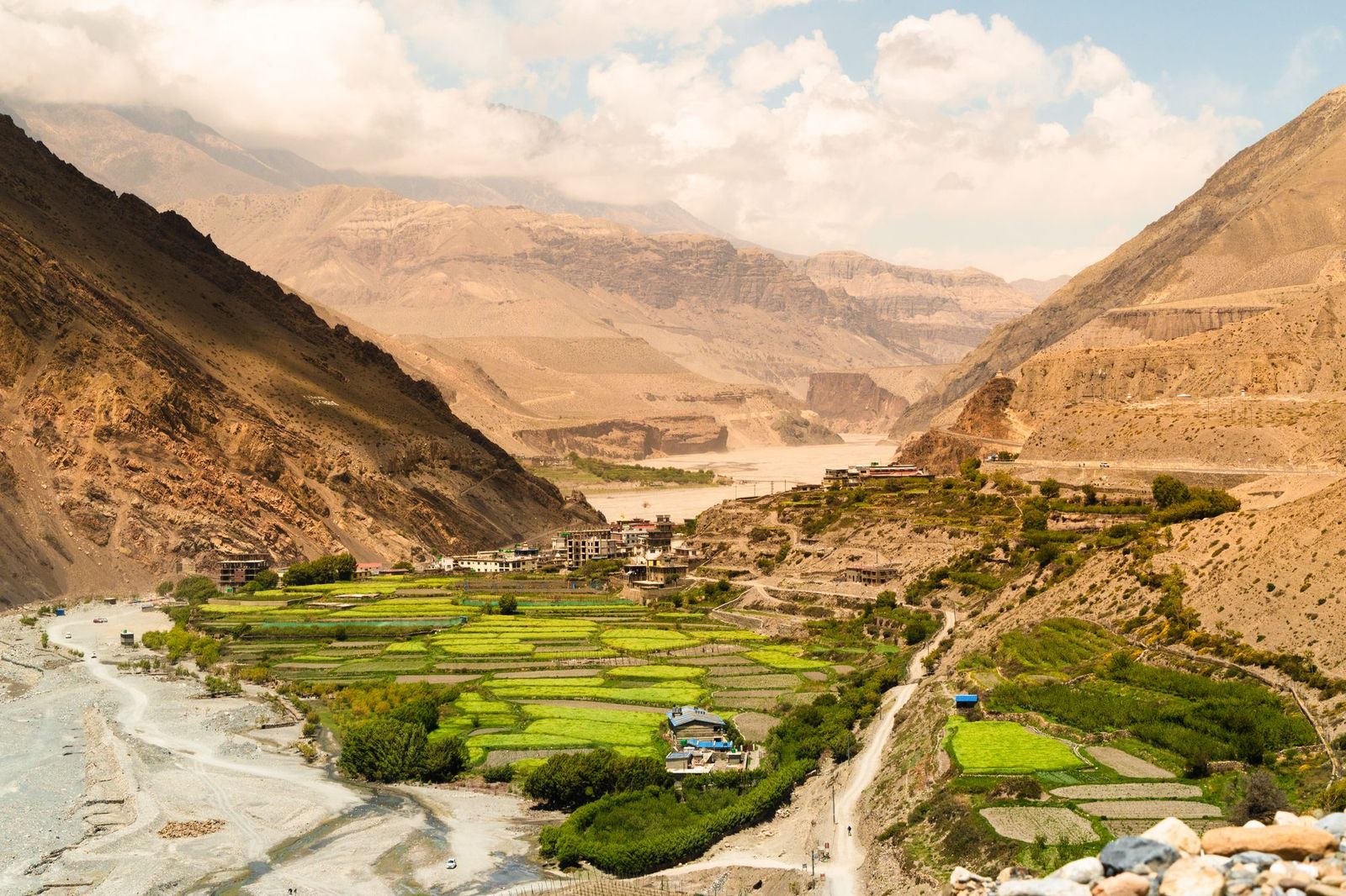 Green terraced village in a dry mountain valley