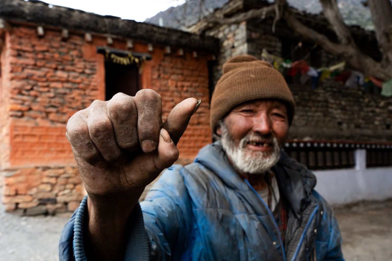 Smiling old man giving a thumbs up