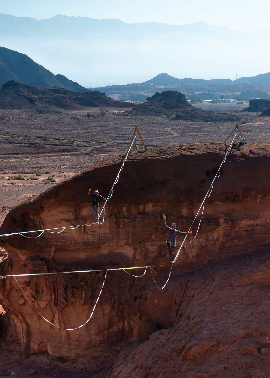 Highline rigged over a red desert canyon in Timna